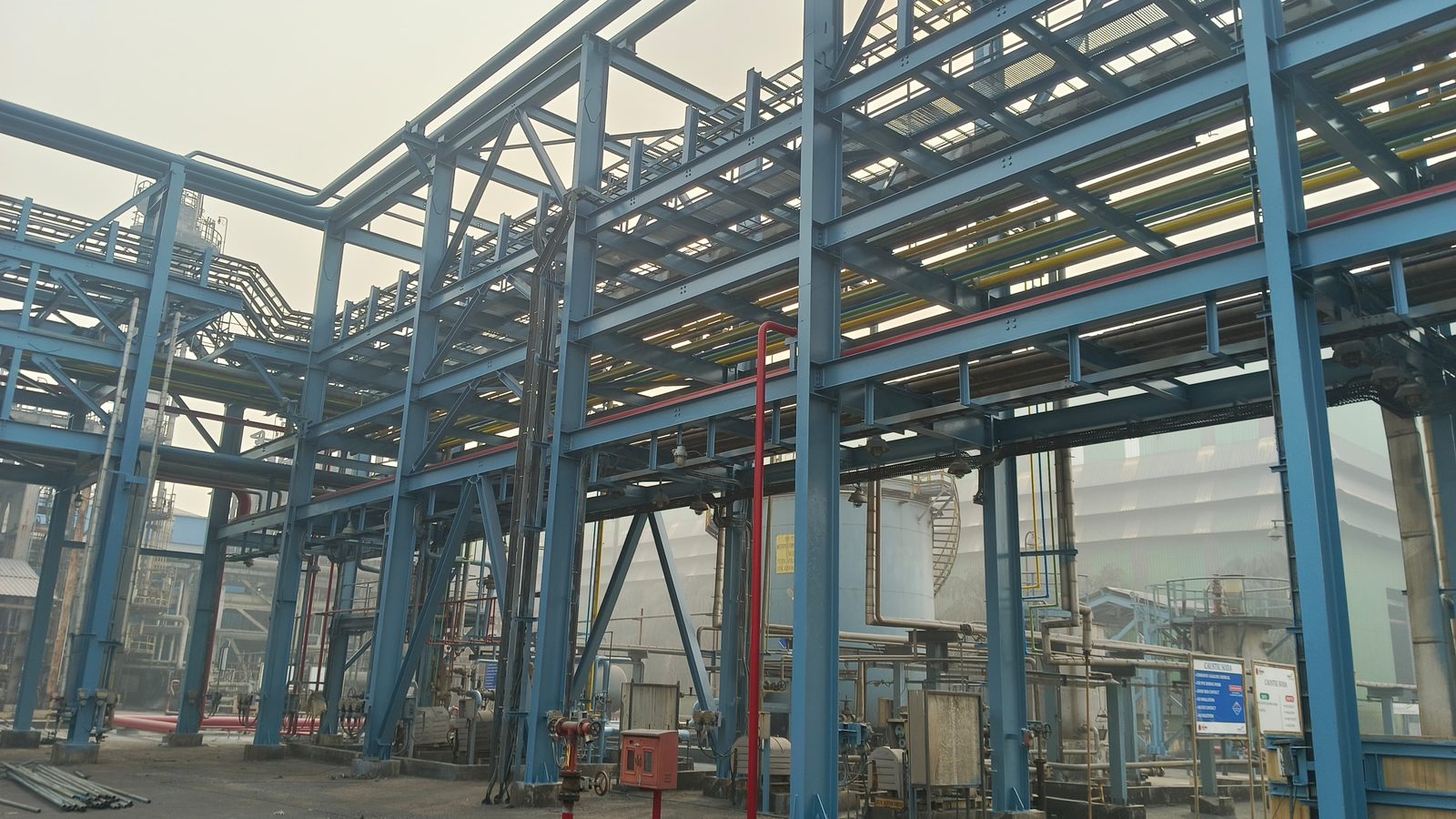 Large horizontal bulk storage tank with protective external coating at a chemical facility